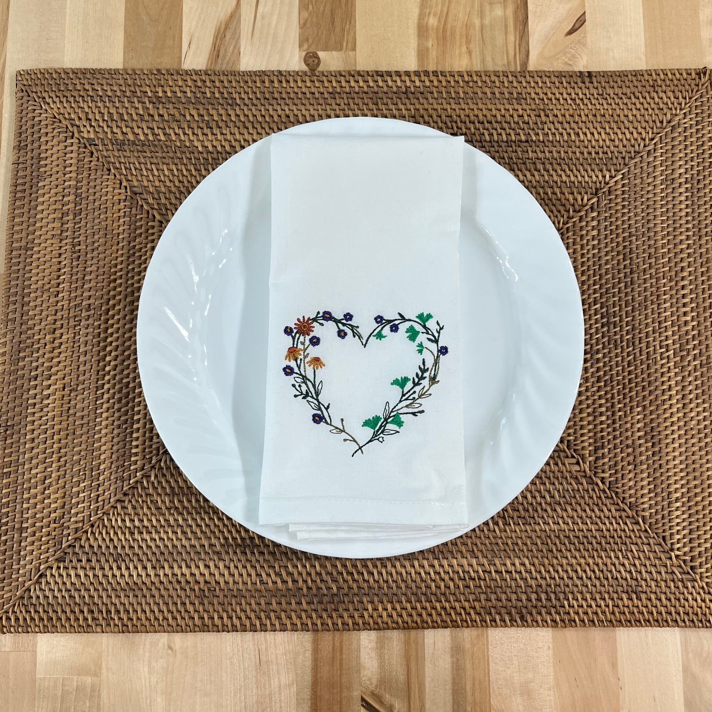 Wildflower heart embroidered on white dinner napkin