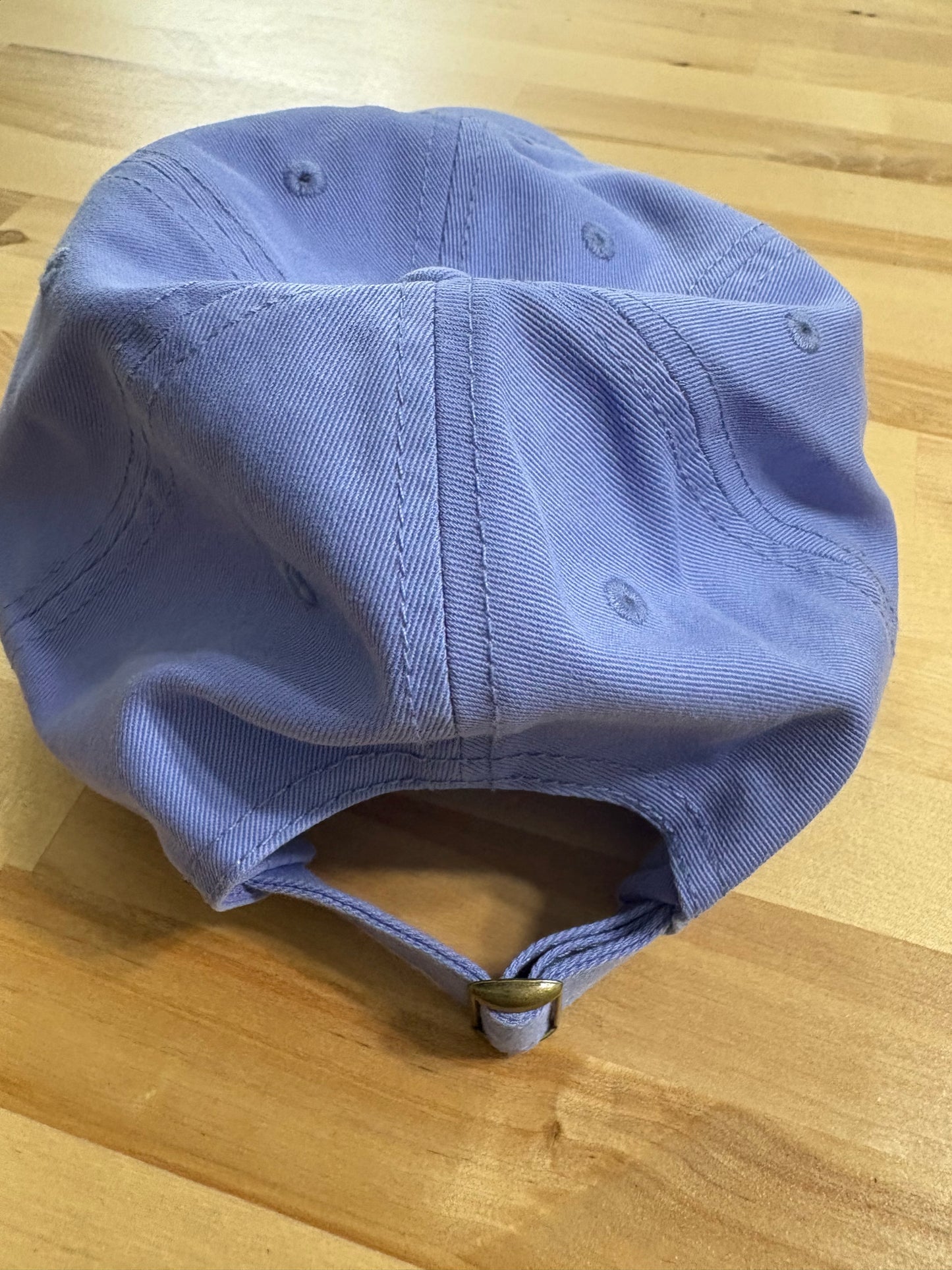 Cat knocking over plant embroidered on light purple cotton dad hat