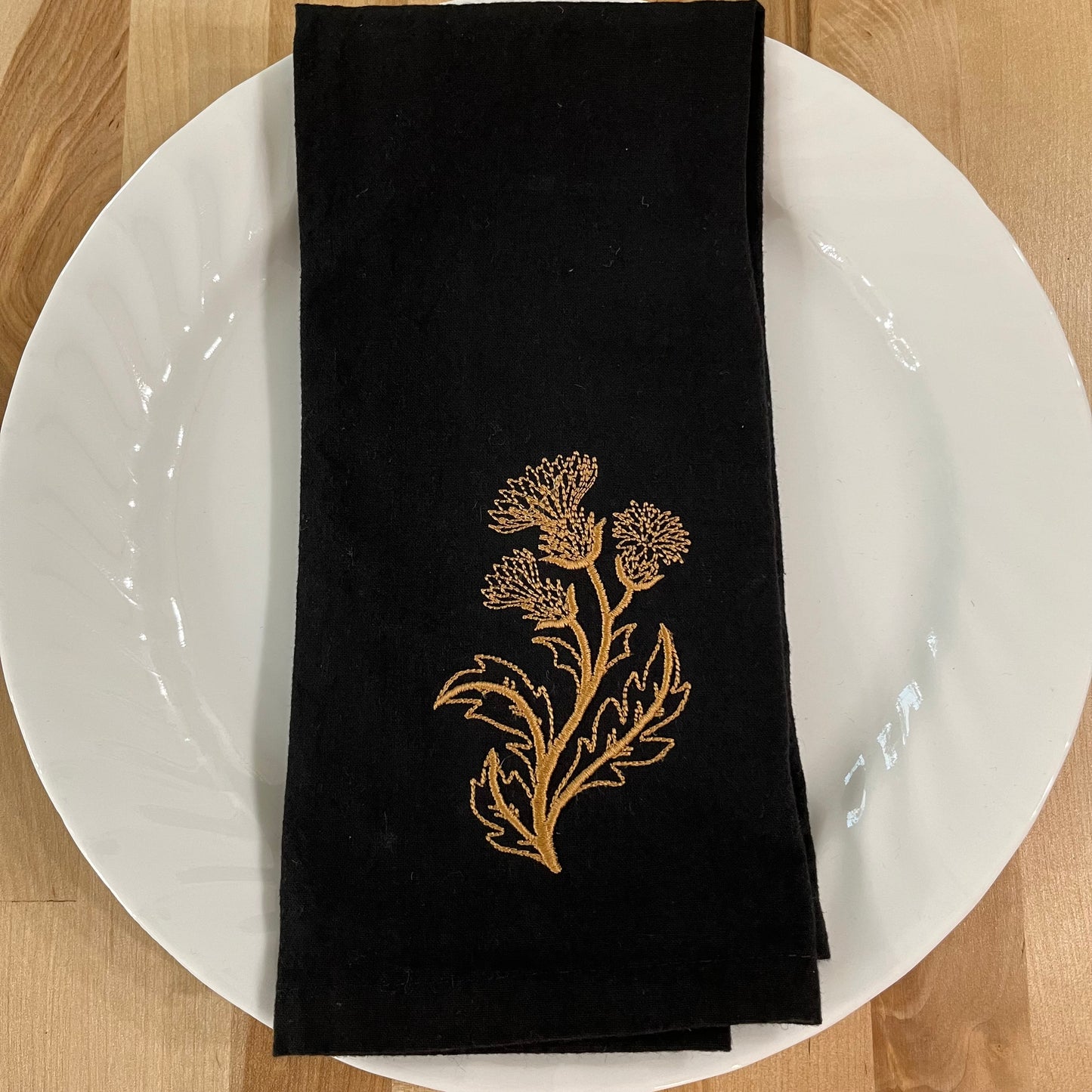 Delicate Botanicals embroidered on black dinner napkin