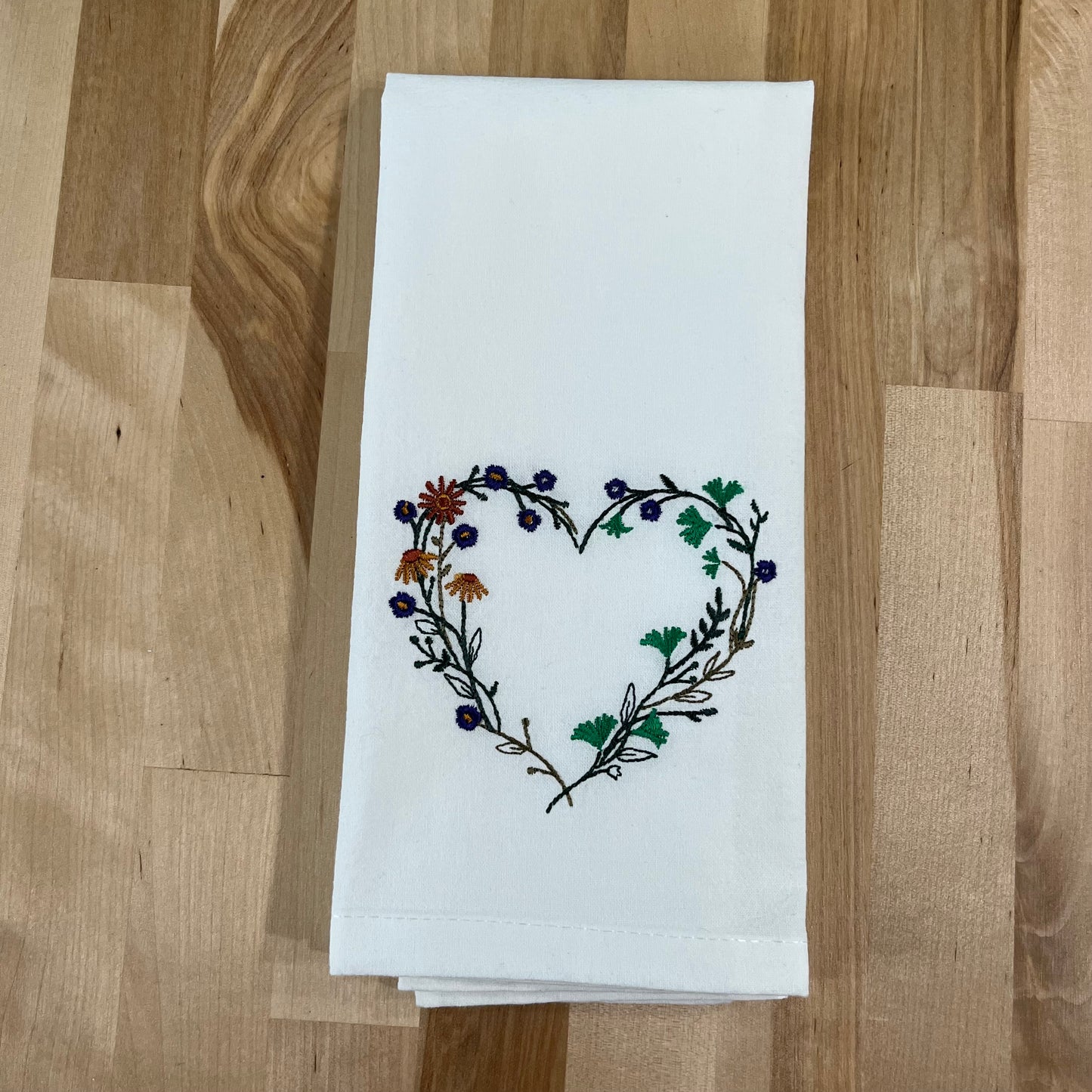 Wildflower heart embroidered on white dinner napkin