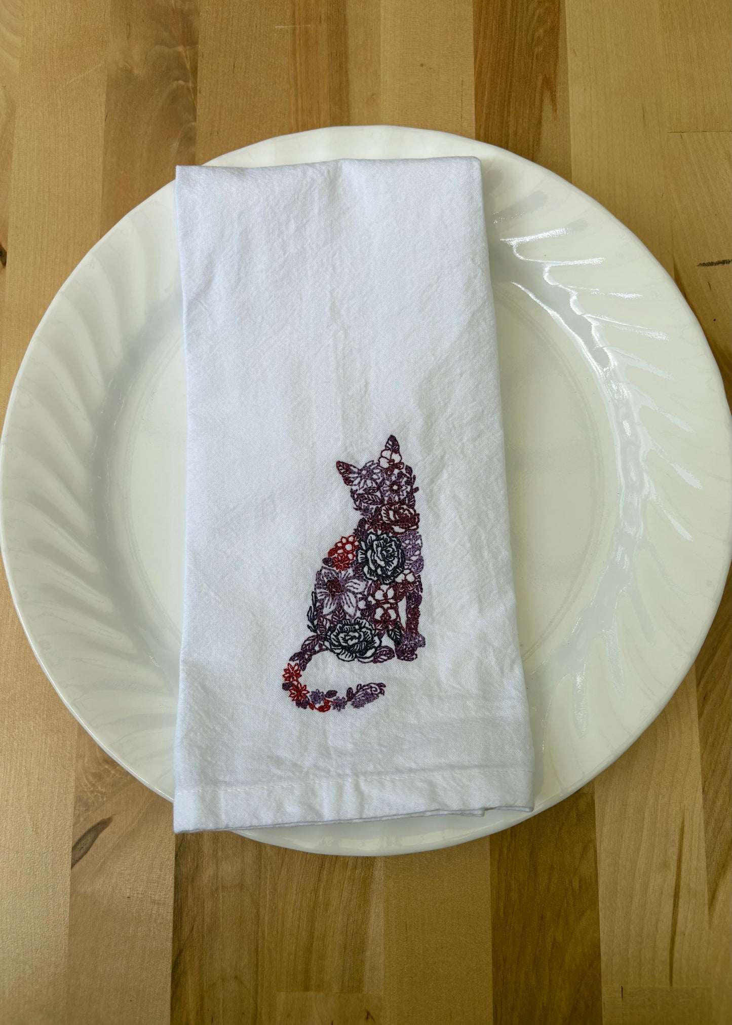Bring a splash of fun to your dining with this delightful floral cat dinner napkin. Set against a crisp white background, it’s not only beautiful but also machine washable and reusable, making it perfect for everyday use or special occasions. Add a playful touch to your table that’s as practical as it is charming!