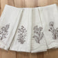 Delicate stems embroidered on natural flour sack napkins
