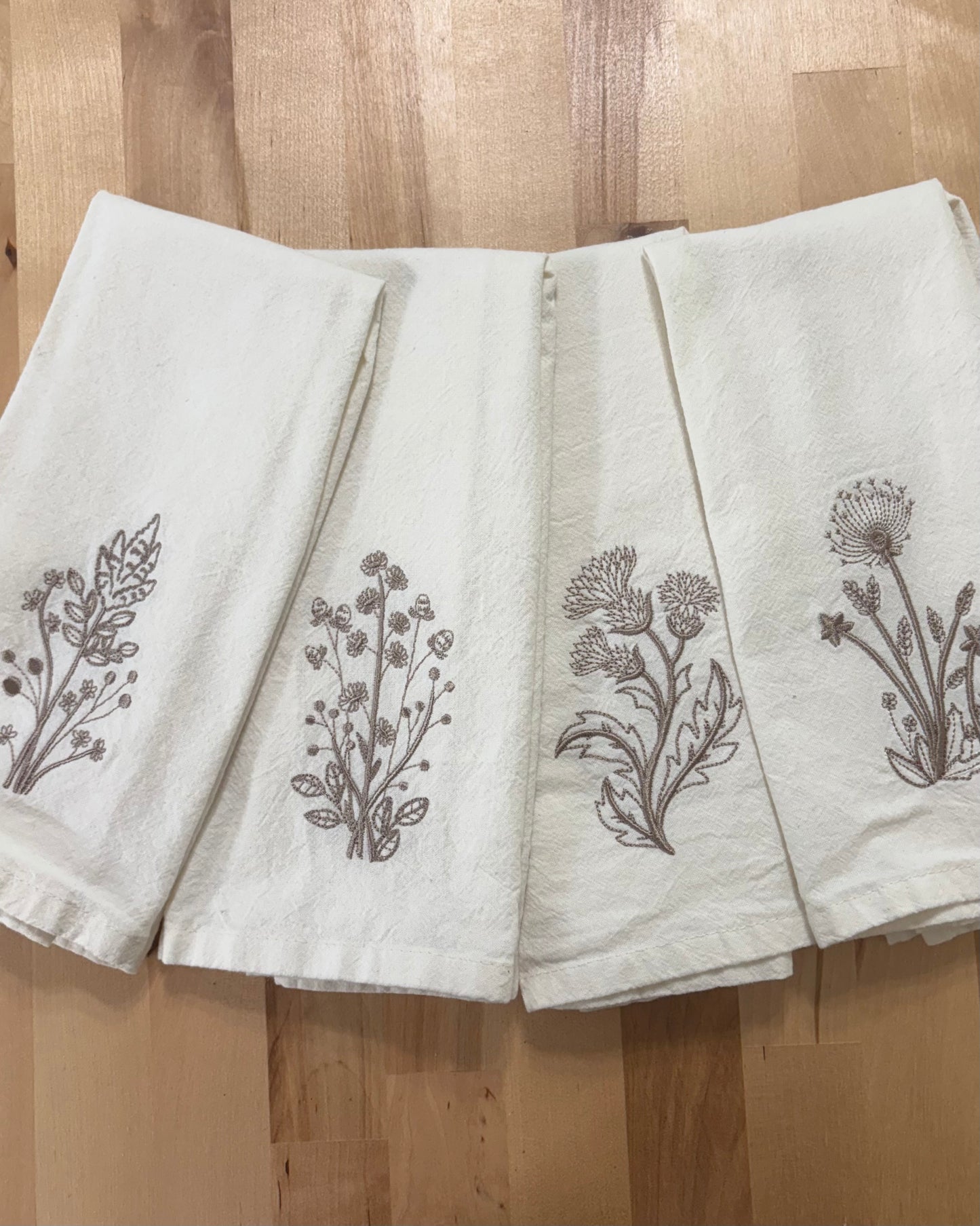 Delicate stems embroidered on natural flour sack napkins