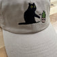 Cat knocking over plant embroidered on ran dad hat