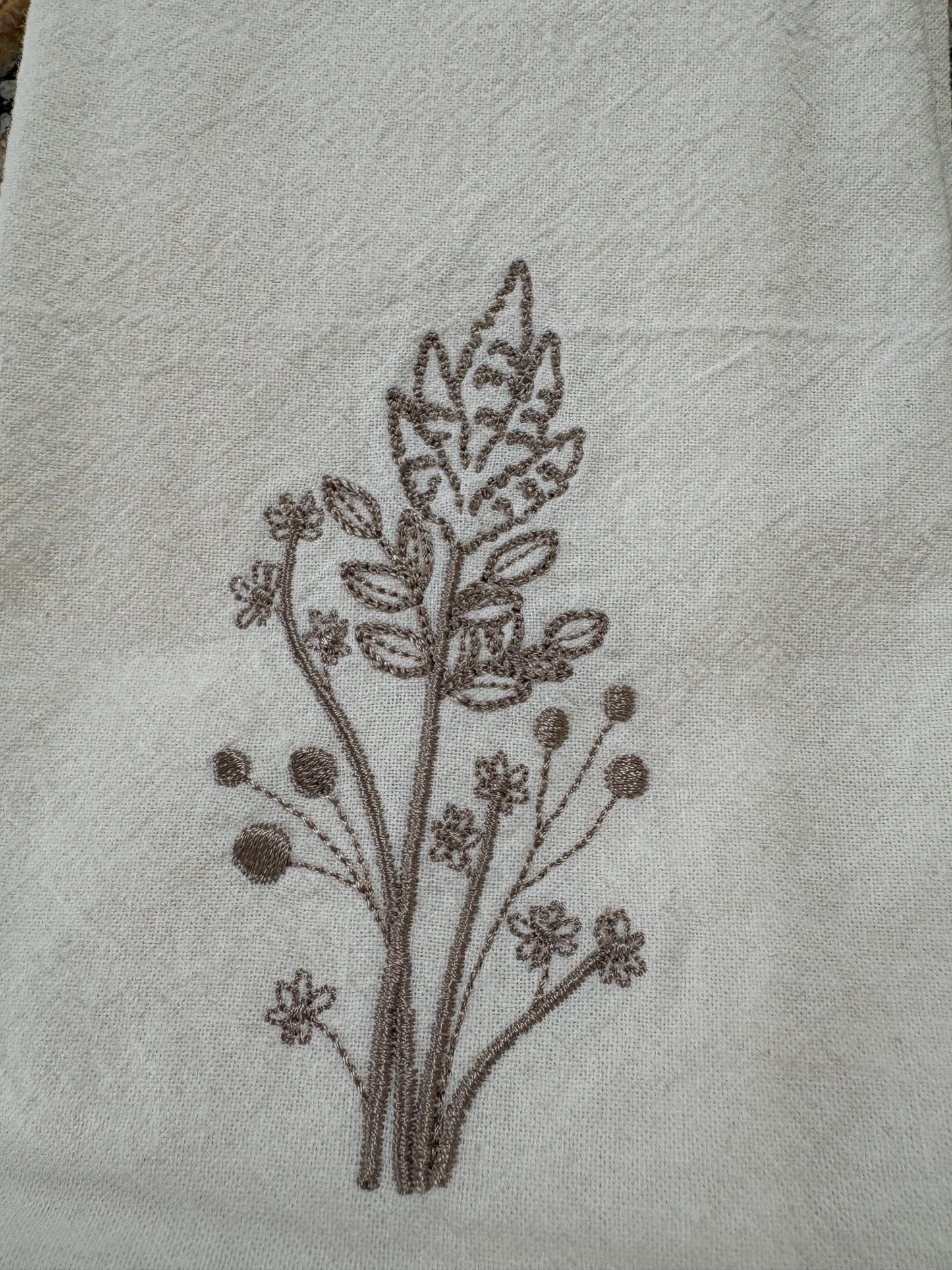 Delicate stems embroidered on natural flour sack napkins