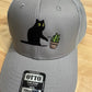 Cat knocking over plant embroidered on light grey Otto trucker hat