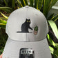 Cat knocking over plant embroidered on light grey Otto trucker hat