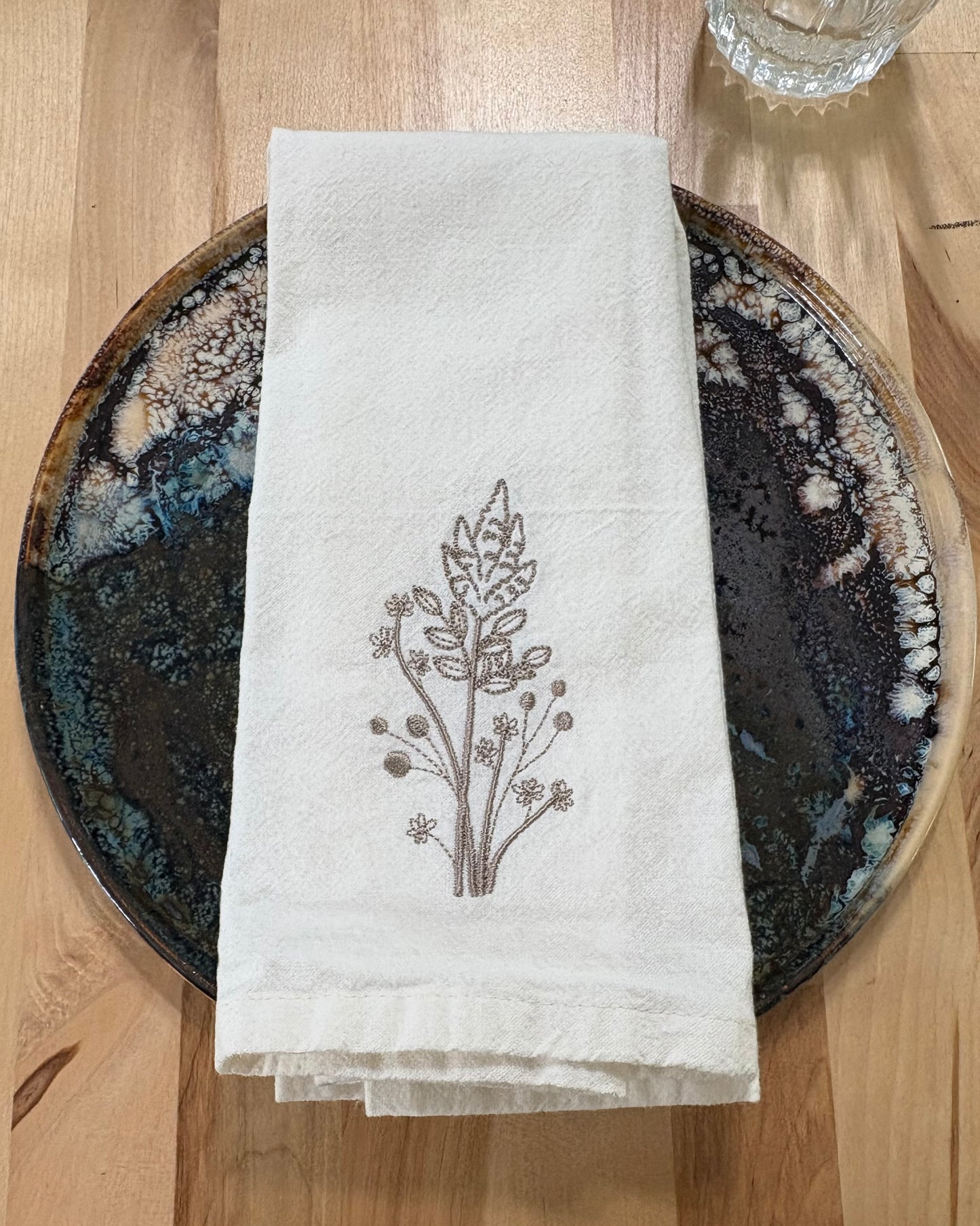 Delicate stems embroidered on natural flour sack napkins