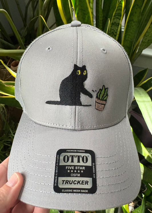 Cat knocking over plant embroidered on light grey Otto trucker hat