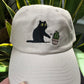 Cat knocking over plant embroidered on ran dad hat