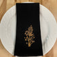 Delicate Botanicals embroidered on black dinner napkin