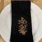Delicate Botanicals embroidered on black dinner napkin