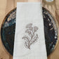 Delicate stems embroidered on natural flour sack napkins