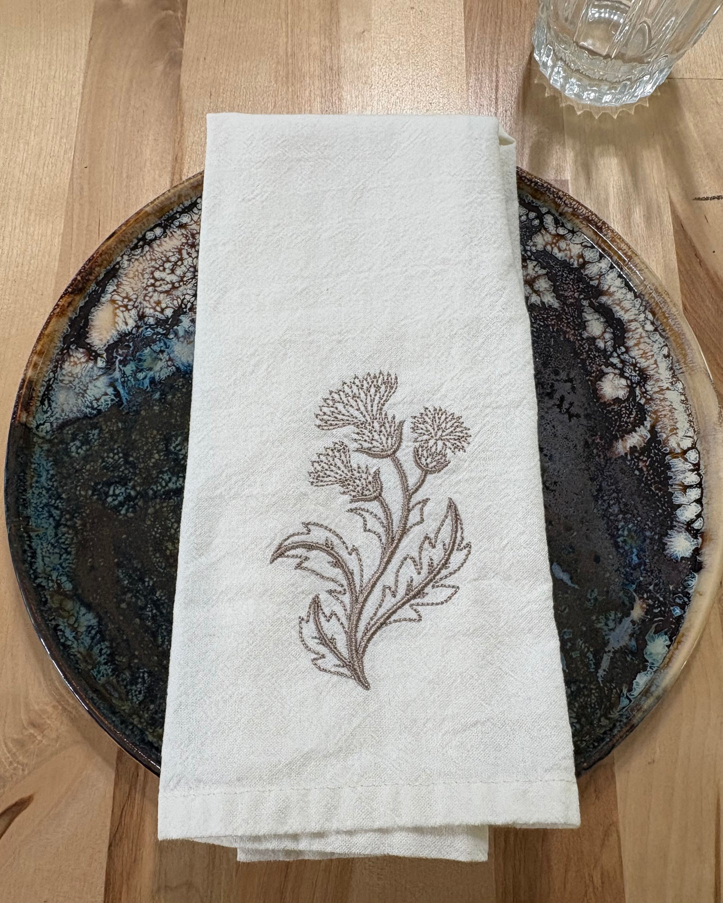 Delicate stems embroidered on natural flour sack napkins