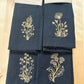 Dinner napkin - Delicate stems embroidered with gold thread on black napkins