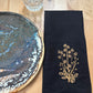 Black cotton napkin with embroidered daisies