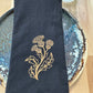 Black cotton napkin with gold embroidered thistle