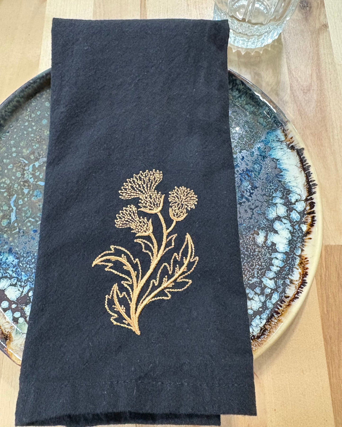 Black cotton napkin with gold embroidered thistle