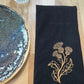 Black cotton napkin with gold embroidered thistle