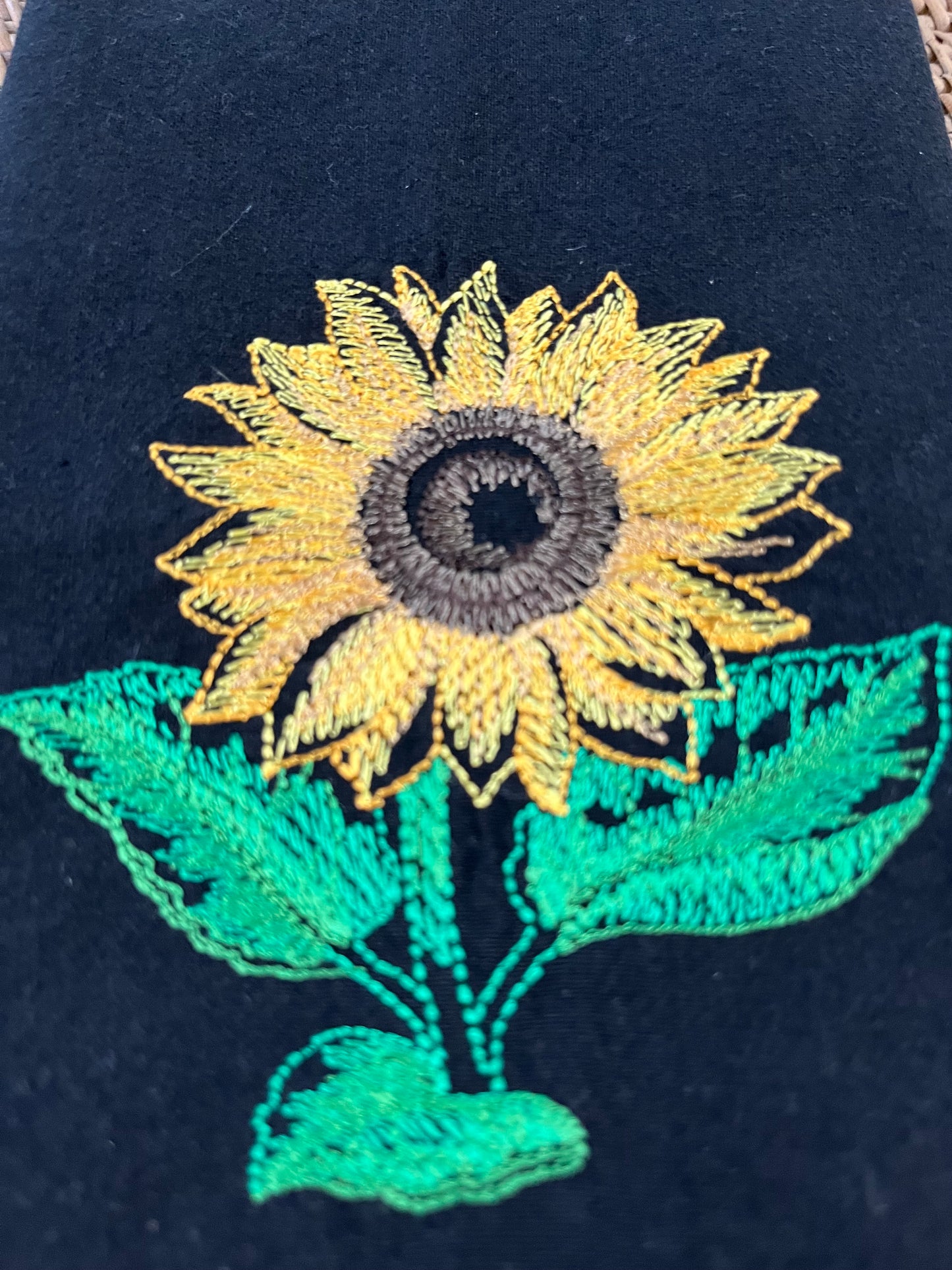 Sunflower embroidered on black dinner napkin