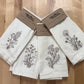 Delicate stems embroidered on natural flour sack napkins