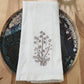 Delicate stems embroidered on natural flour sack napkins