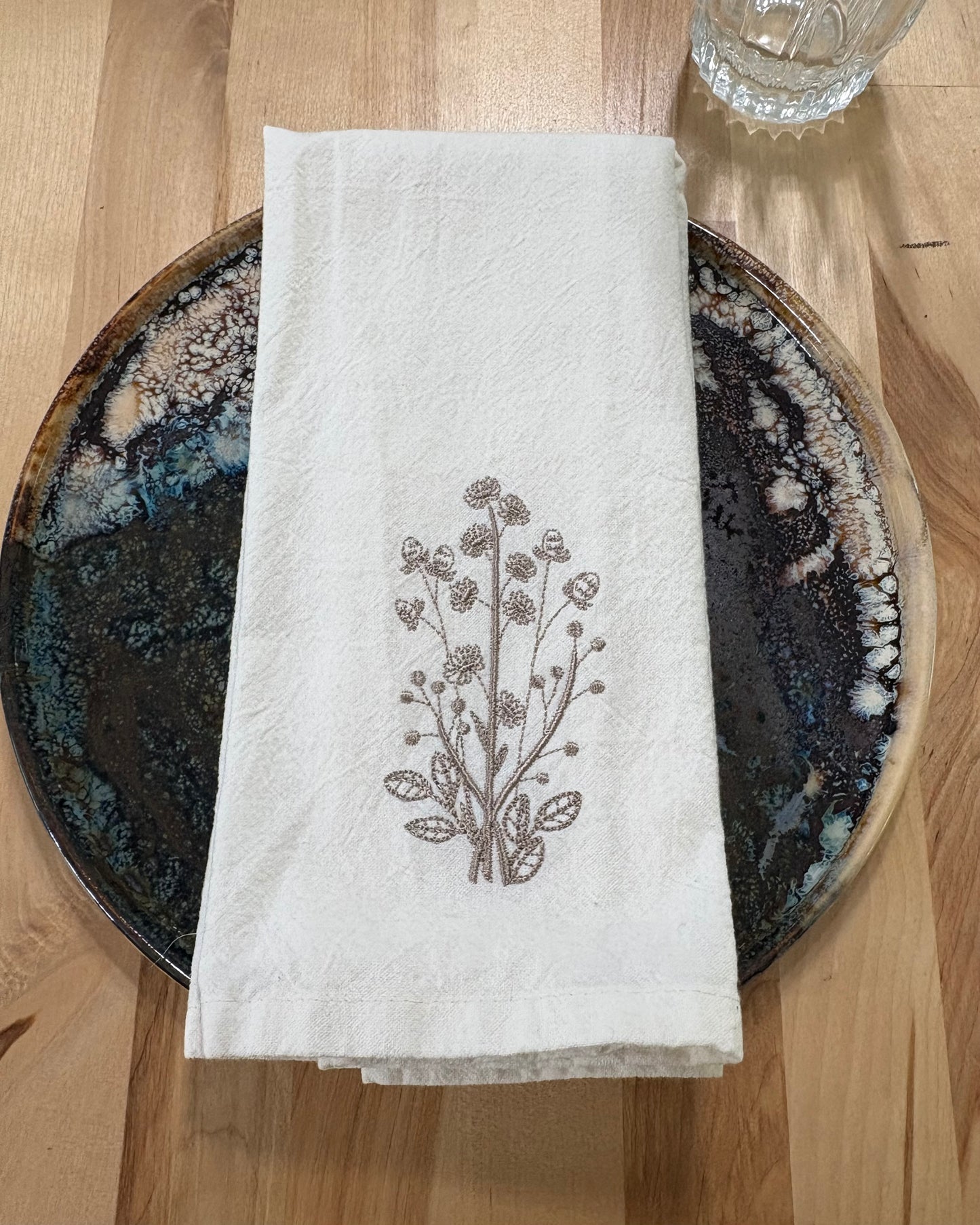 Delicate stems embroidered on natural flour sack napkins