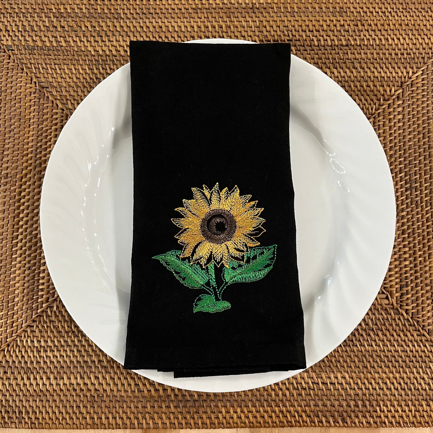 Sunflower embroidered on black dinner napkin