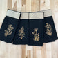 Delicate Botanicals embroidered on black dinner napkin