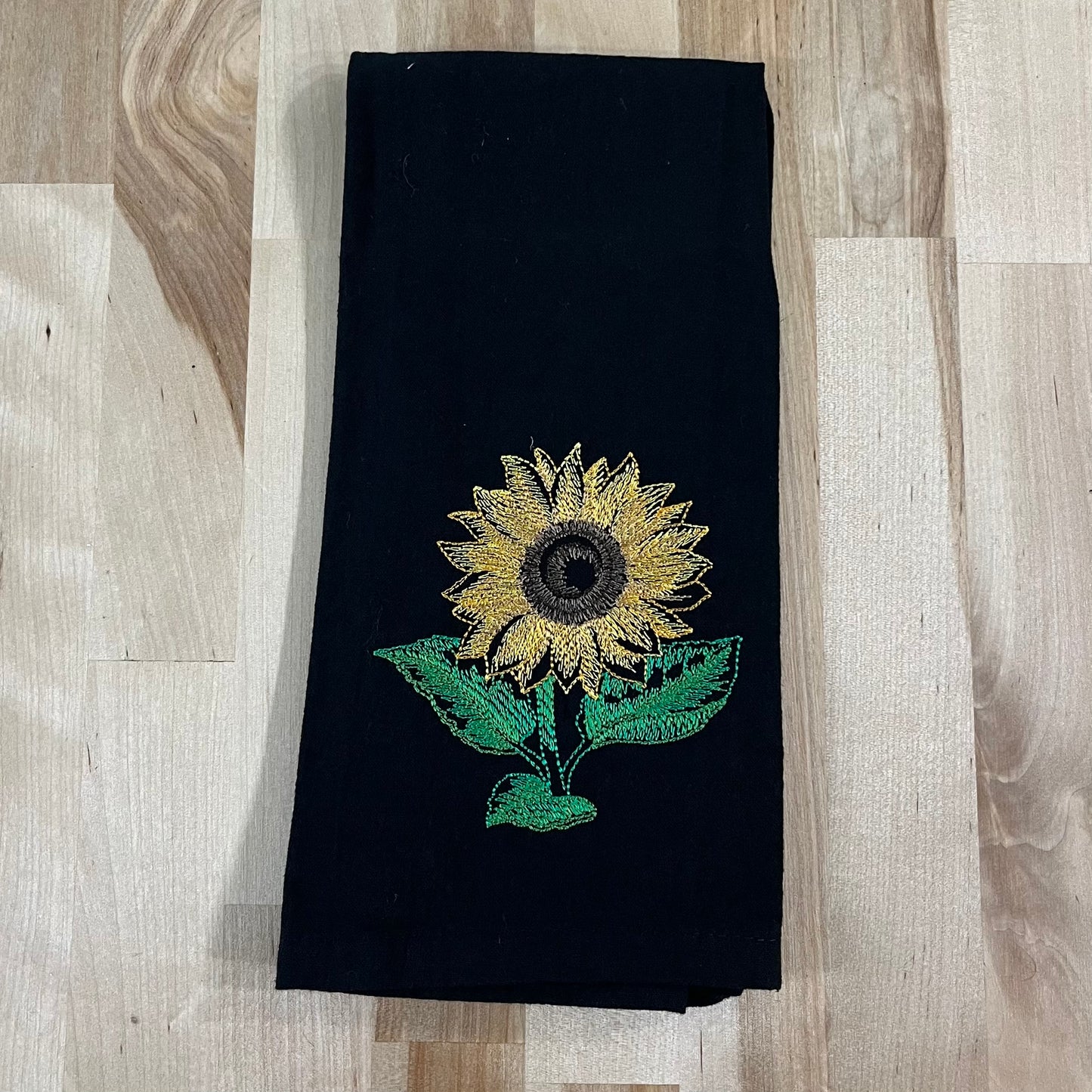 Sunflower embroidered on black dinner napkin