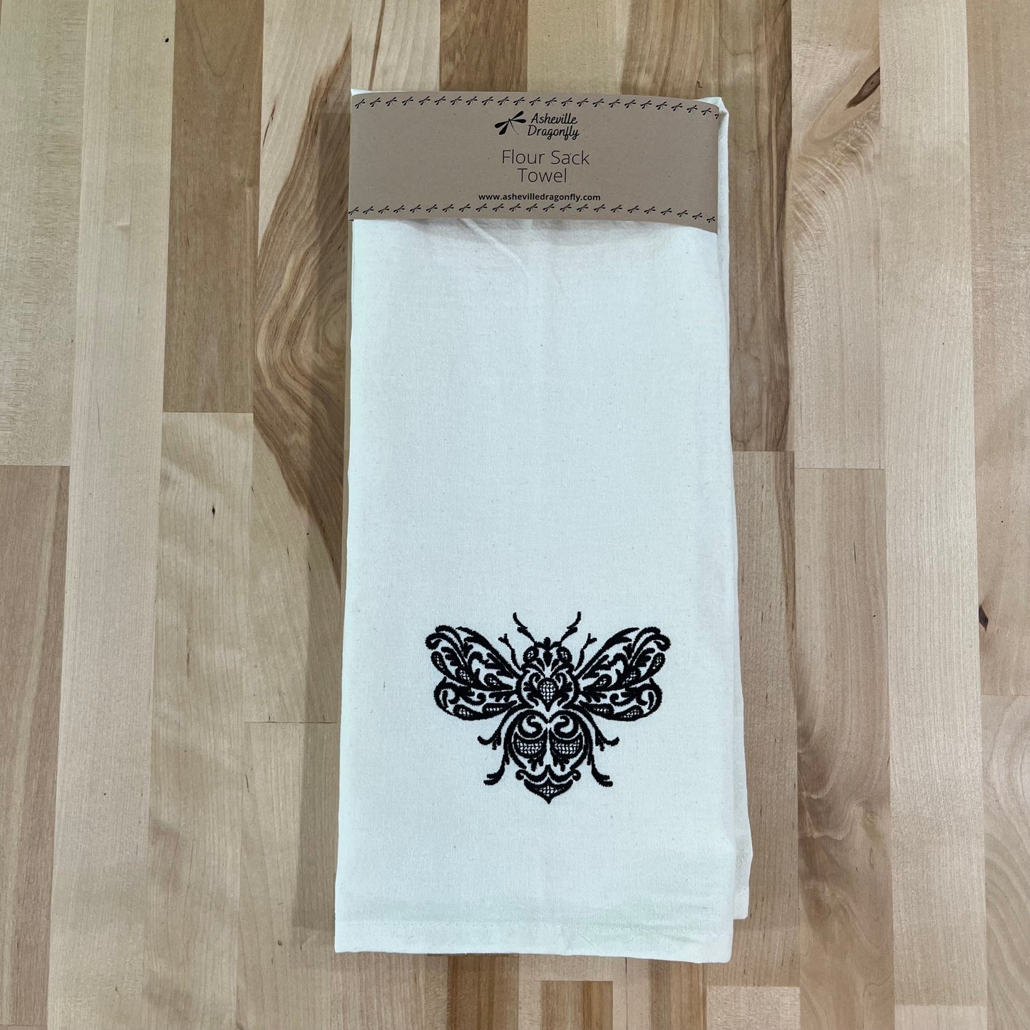 The Exquisite Buzzing Bee combines practicality and beauty in one kitchen towel. Made of cotton flour sack material and embroidered with an elegant bee, it is not only machine washable but also a charming addition to any kitchen. Measuring at 28”x28”, it is the perfect size for all your kitchen needs.