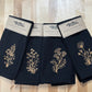 Set of black napkins with gold embroidered botanical stems 