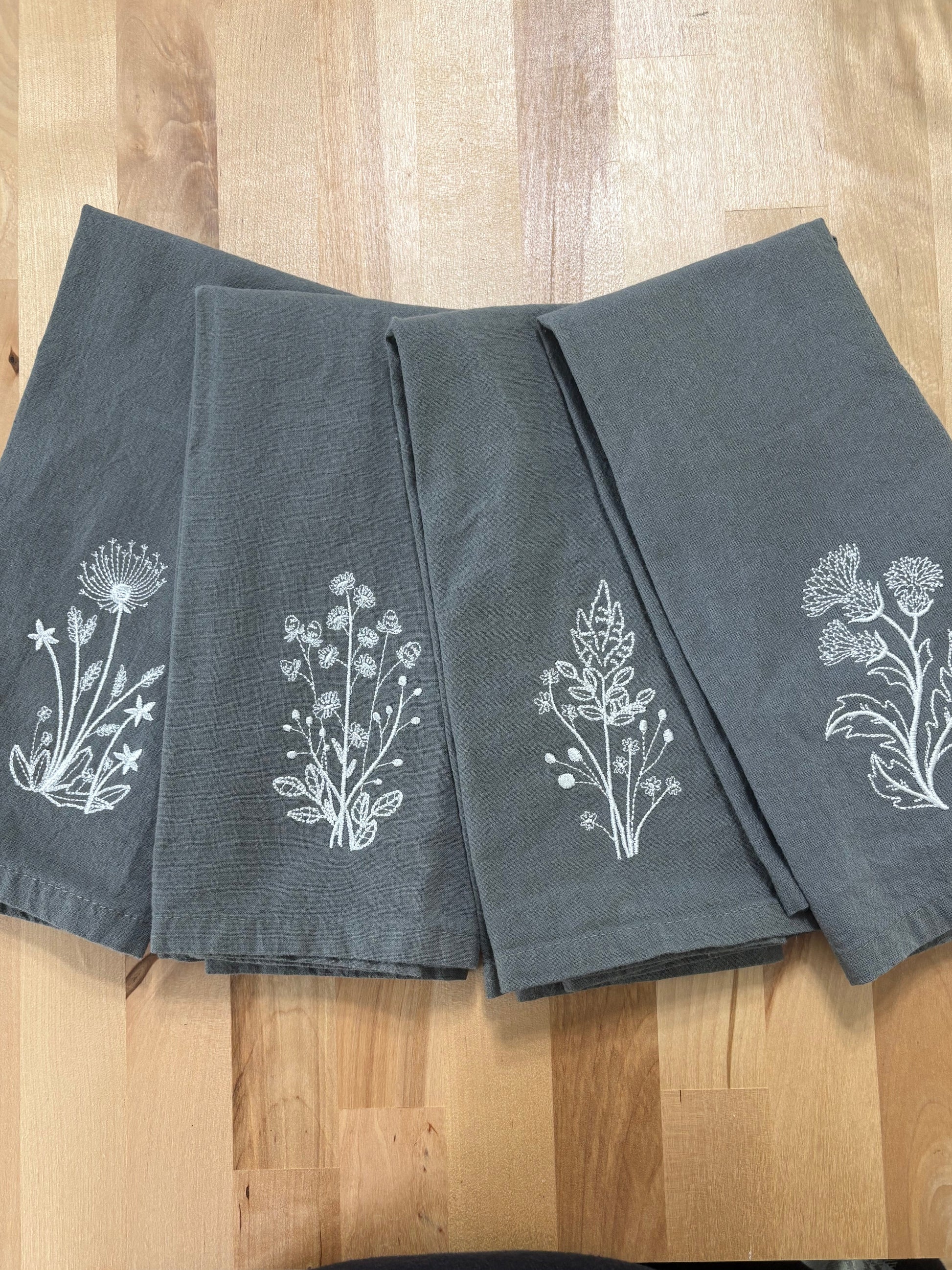 et of grey napkins embroidered with white stems